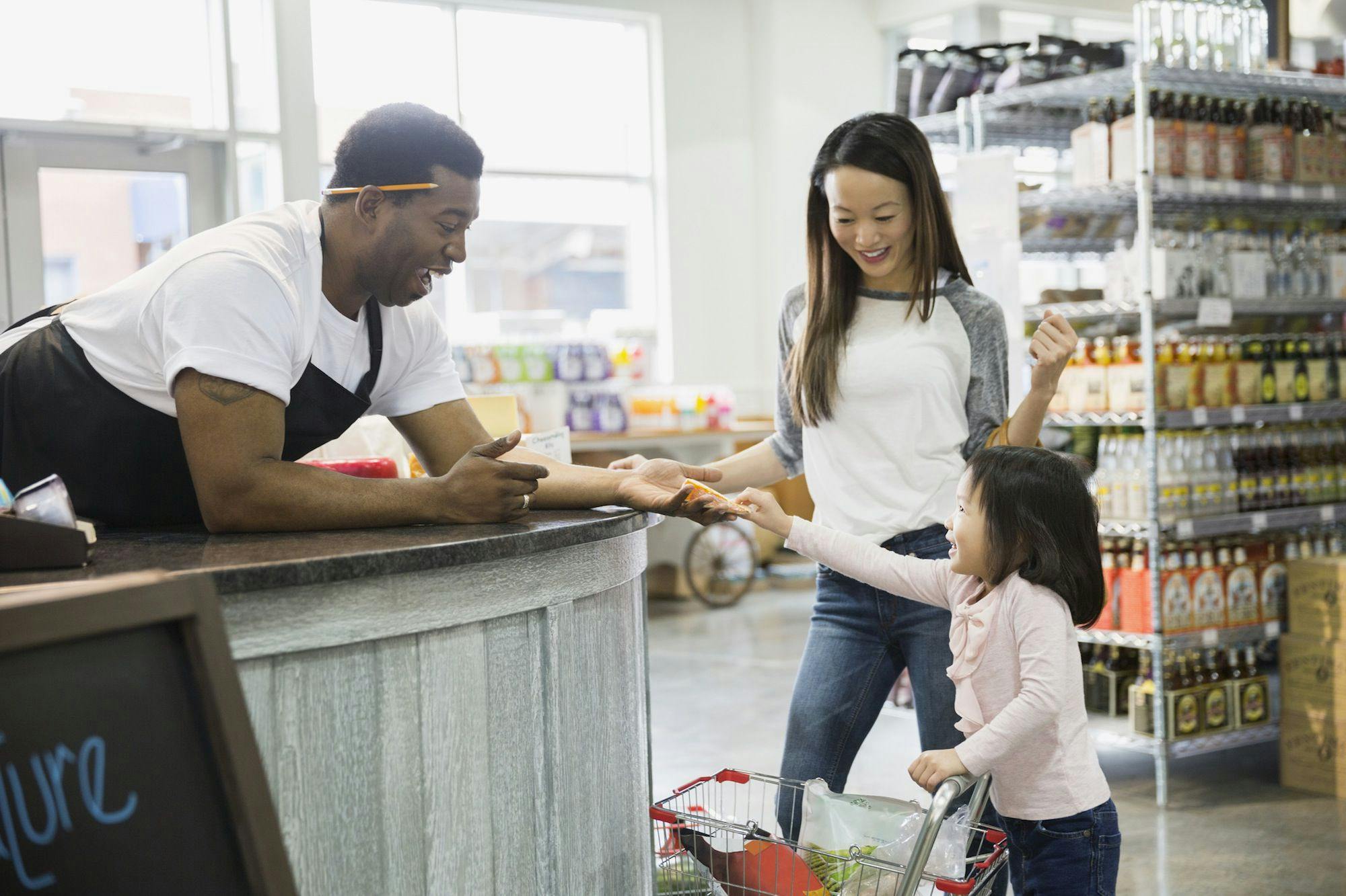 a kid paying in a grocery store