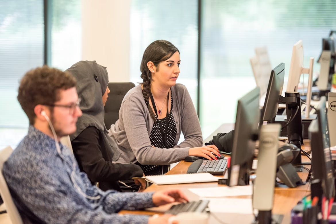 A customer service agent in the UAE working with her teammate