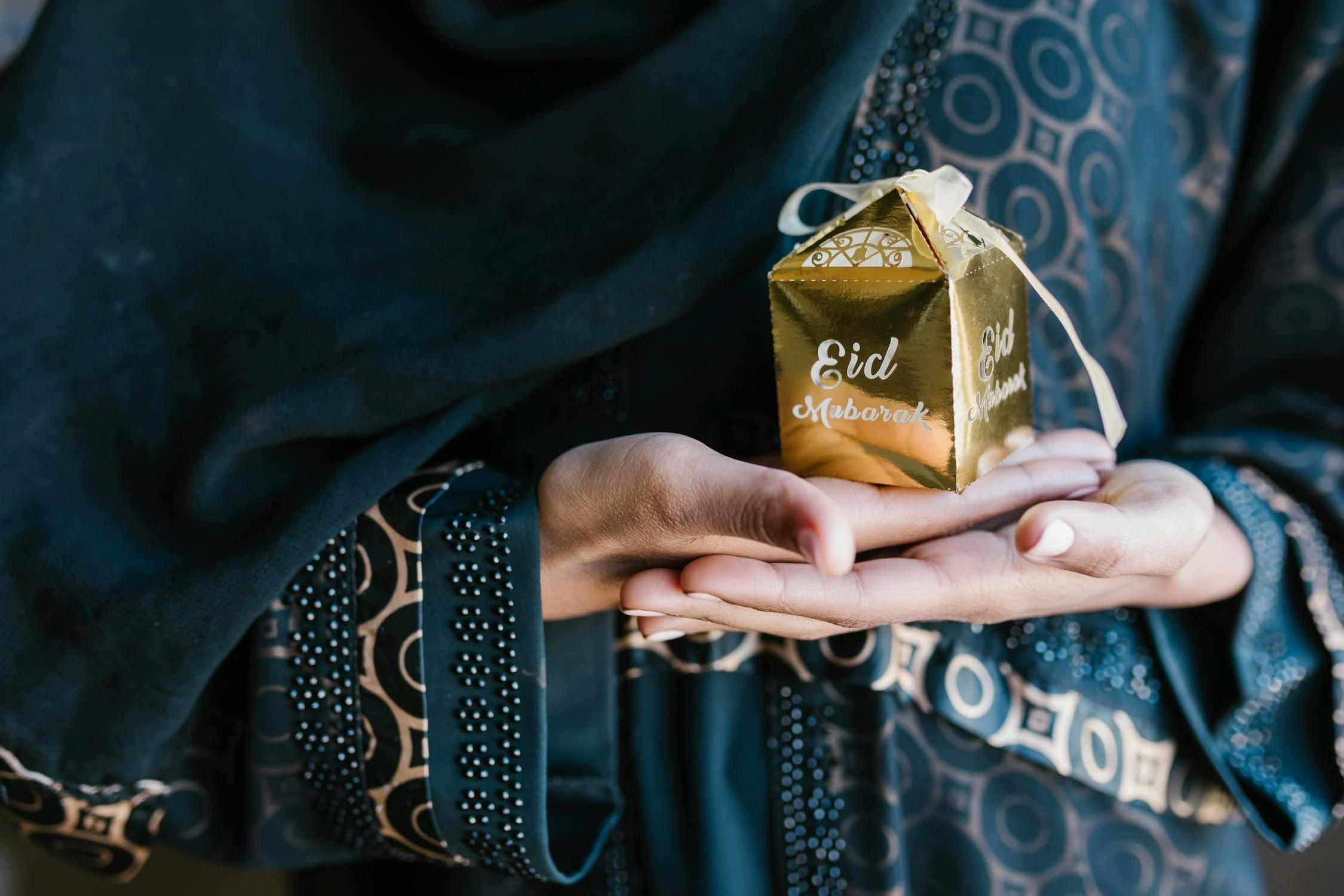 Woman holding a gift in preparation of Ramadan and Raya