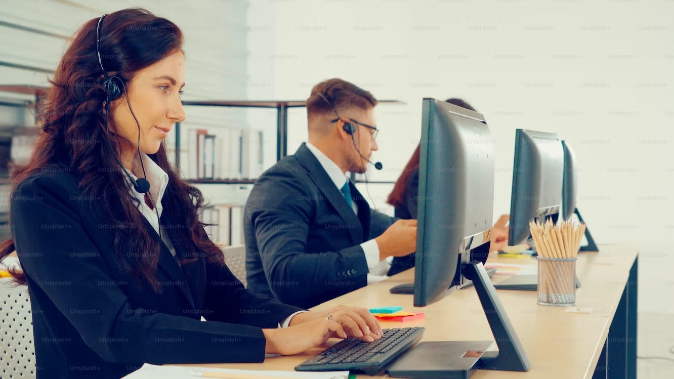 Customer service agents working in front of their desktop